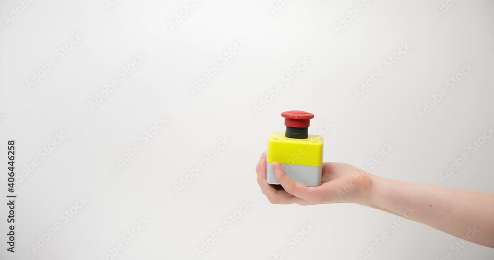 The female hand presses the red button on a light background The female hand presses the red button on a light background