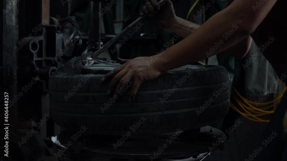 mechanic applying grease for remove old damaged and worn out of car tire tread by tire removal machinery equipment repairing . engineer repair rubber from wheel disc in workshop at car service garage mechanic applying grease for remove old damaged and worn out of car tire tread by tire removal machinery equipment repairing . engineer repair rubber from wheel disc in workshop at car service garage