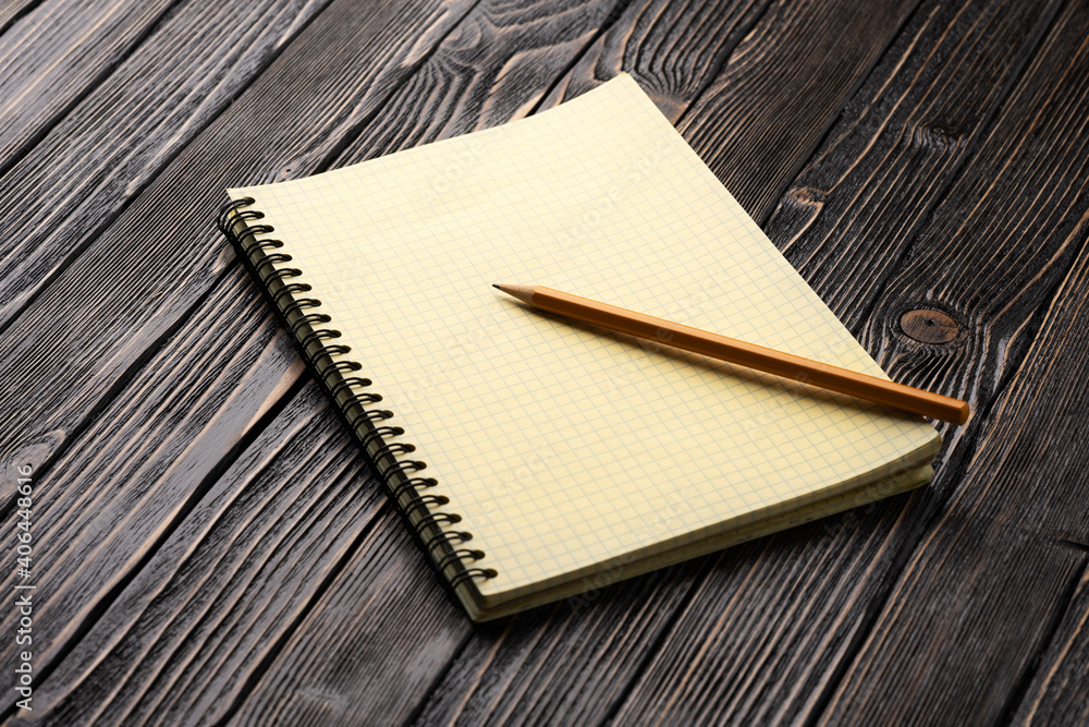 yellow notepad and pencil on brown wooden table yellow notepad and pencil on brown wooden table