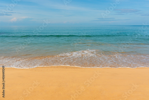 View of blue sky, blue sea, small wave and yellow sand that is signature of beautiful seascape scene at Phuket Province, Thailand in the morning of holiday.