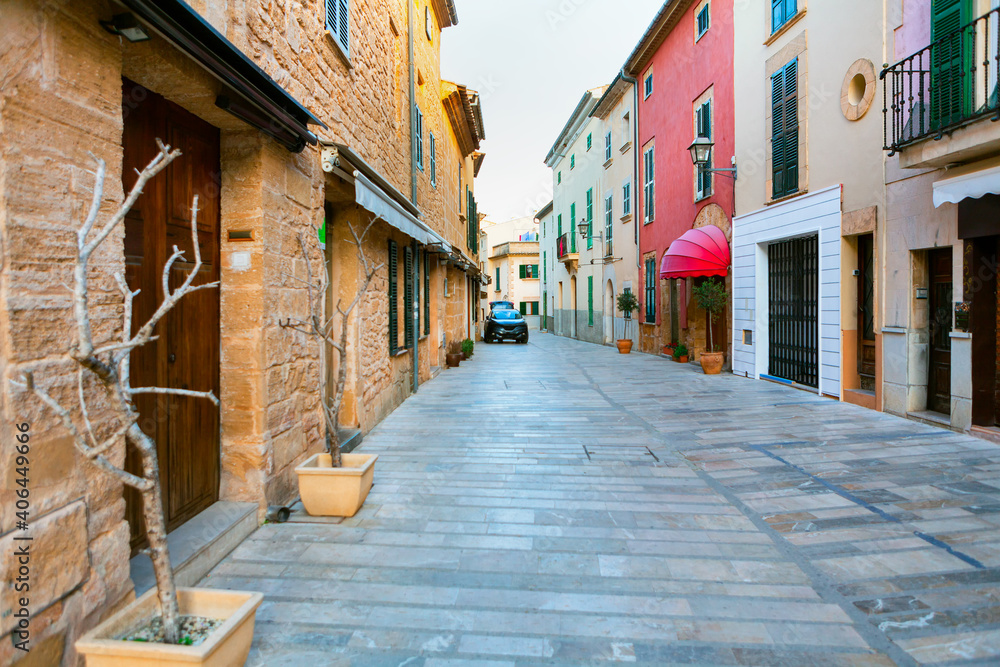 Narrow street with residential houses . Spanish pedestrian street with showcases and homes  