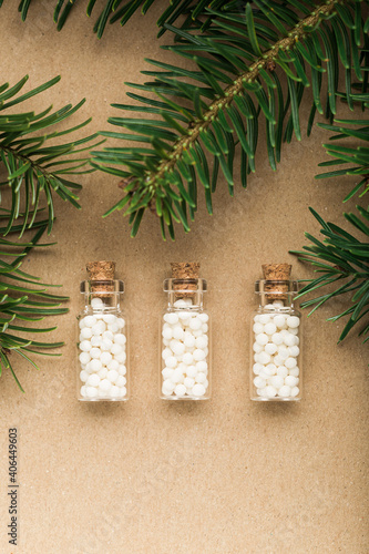 Homeopathic pills with pine tree on cork background. Homeopathy, naturopathy and alternative medicine