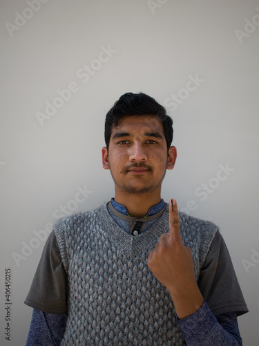 young man showing his ink marked finger. election in pandemic