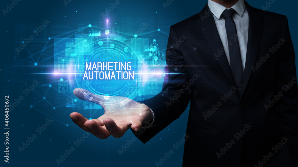 Man hand holding MARKETING AUTOMATION inscription, technology concept Man hand holding MARKETING AUTOMATION inscription, technology concept