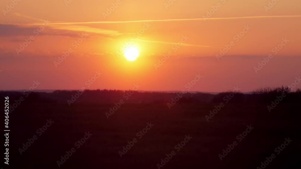 Beautiful sunset with a hazy mood. A silhouette of trees with a wide view into the lonely nature. Beautiful sunset with a hazy mood. A silhouette of trees with a wide view into the lonely nature.