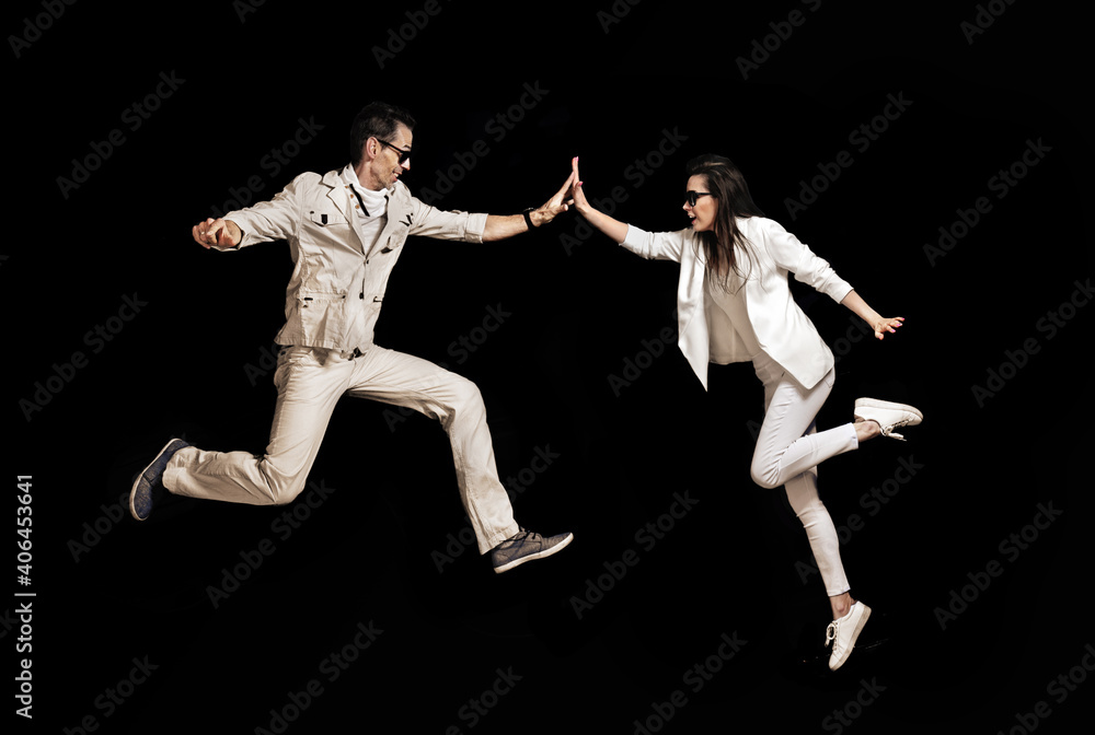 Talented couple dancing on the black background