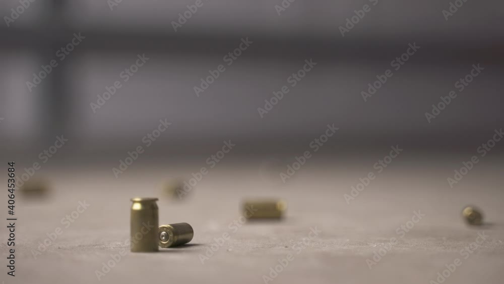 Multiple bullet shells falling to the ground and bouncing. Multiple bullet shells falling to the ground and bouncing.