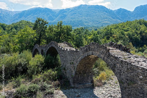 View of the traditional stone Kalouta Bridge in Epirus, Greece. © dinosmichail