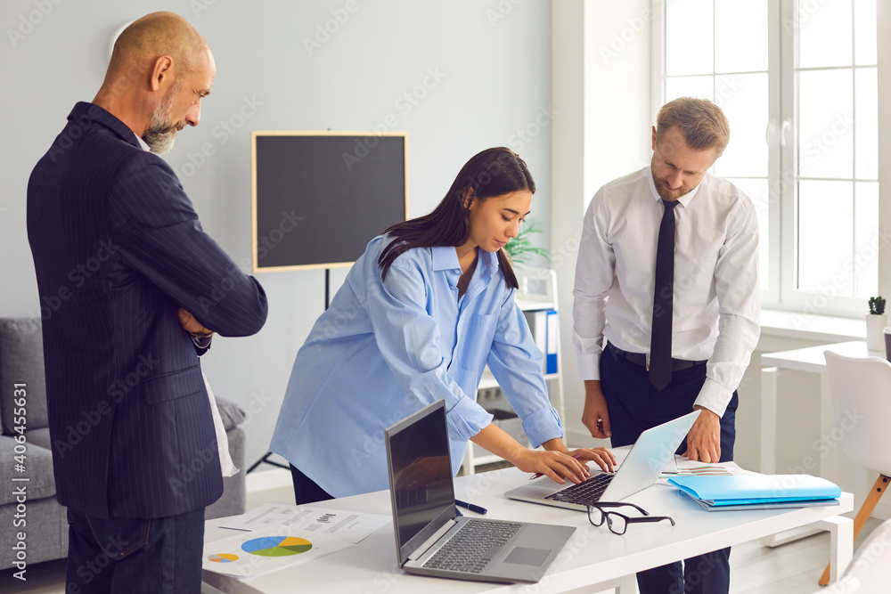 Fototapeta premium Creative group of diverse business colleagues working with laptop in modern office.