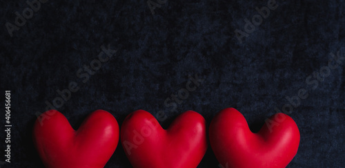 red balloons in the form of a heart on a black background.happy valentines day.  three red hearts on black background