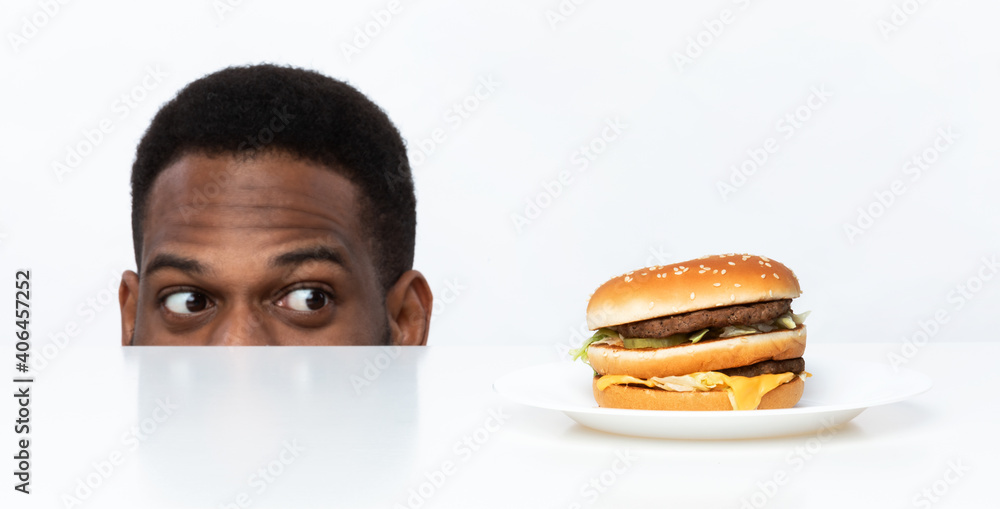 Hungry African American Man Looking At Burger, White Background, Panorama Hungry African American Man Looking At Burger, White Background, Panorama