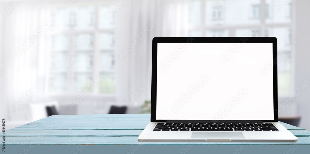 Laptop with blank screen on white table with office window view. Home interior or office background Laptop with blank screen on white table with office window view. Home interior or office background