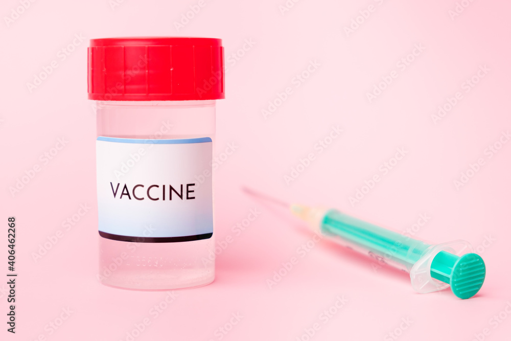 Covid-19 vaccine in the bottle and disposable syringe for injection on the pink background. Prevention of coronavirus, Sars-Cov-2. Covid-19 vaccine in the bottle and disposable syringe for injection on the pink background. Prevention of coronavirus, Sars-Cov-2.