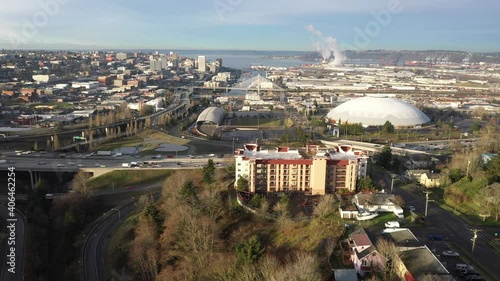 Cinematic drone tracking shot of downtown Tacoma, harbor, dome, Commencement Bay, cargo terminals, I-5 interstate, Puget Sound, port of Tacoma, near Seattle, Washington, Pierce County photo