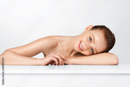 Shirtless Ginger-Haired Young Lady Posing Smiling To Camera  White Background