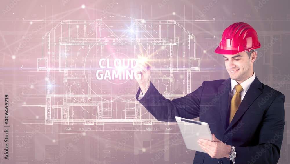 Handsome architect with helmet drawing CLOUD GAMING inscription, new technology concept Handsome architect with helmet drawing CLOUD GAMING inscription, new technology concept