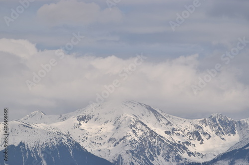 Snowy mountains and cloudy sky © Jeno