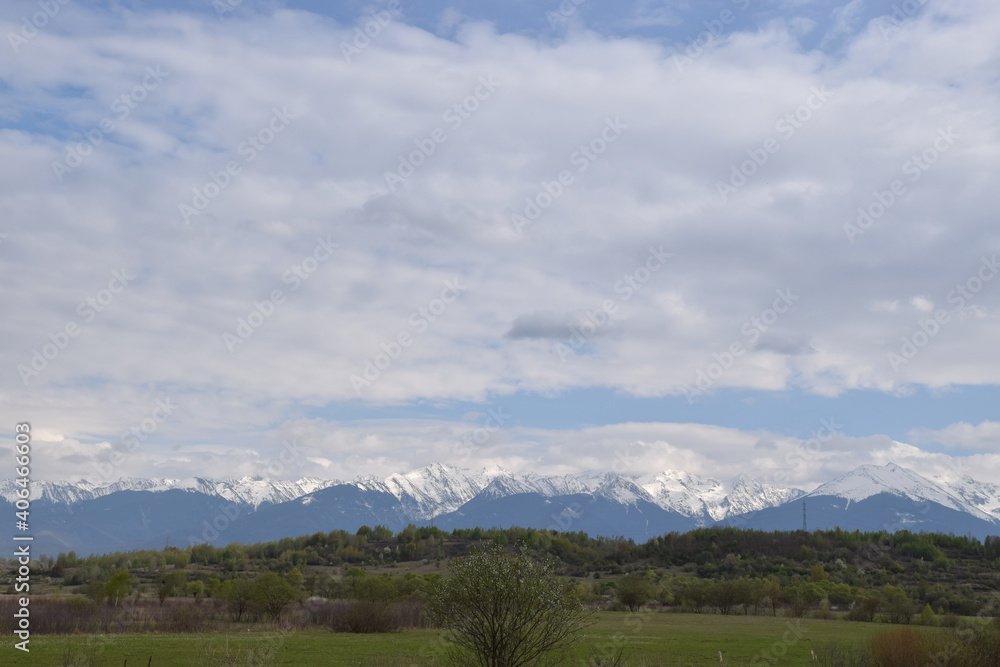 Snowy mountains and cloudy skies