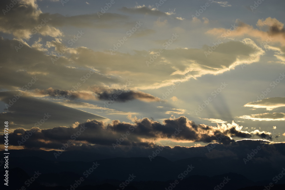 Sun close to sunset illuminates clouds from below Sun close to sunset illuminates clouds from below