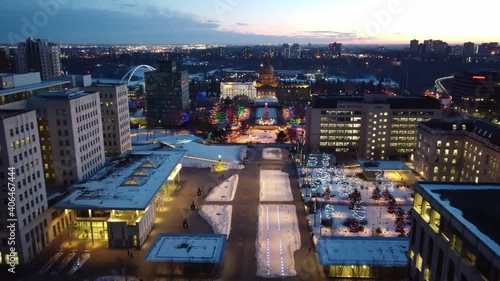 4k Twilight Aerial fly over LED runway winter post Modern Provincial Legislature Buildings centered with a Beaux Arts dome rooftop government structure of Capital City of Edmonton Alberta Canada 3-4 photo