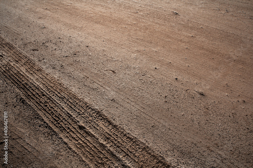 Tyre track on dirt sand or mud, Picture in retro or grunge tone. Car drive on sand. off road track. Track on grass field. Track in farm.