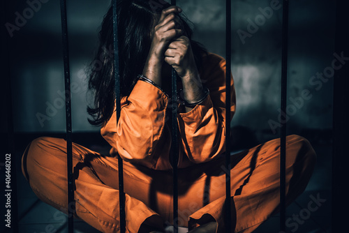 Fotografie, Obraz Portrait of women desperate to catch the iron prison,prisoner concept,thailand people,Hope to be free,If the violate the law would be arrested and jailed