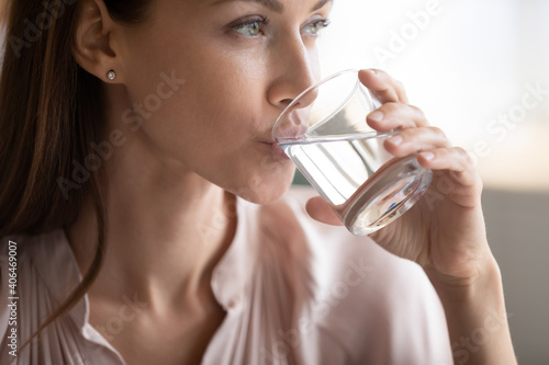 Cuadro en lienzo Close up attractive woman drinking pure fresh mineral water, preventing dehydrat