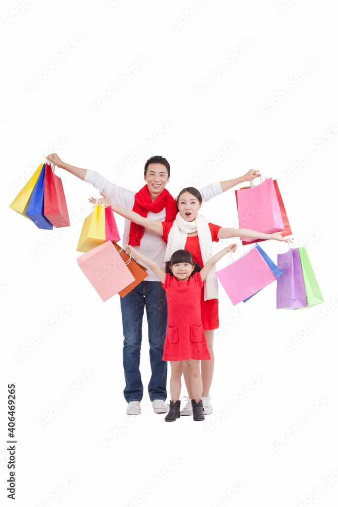 Portrait of daughter with parents,holding shopping bags 