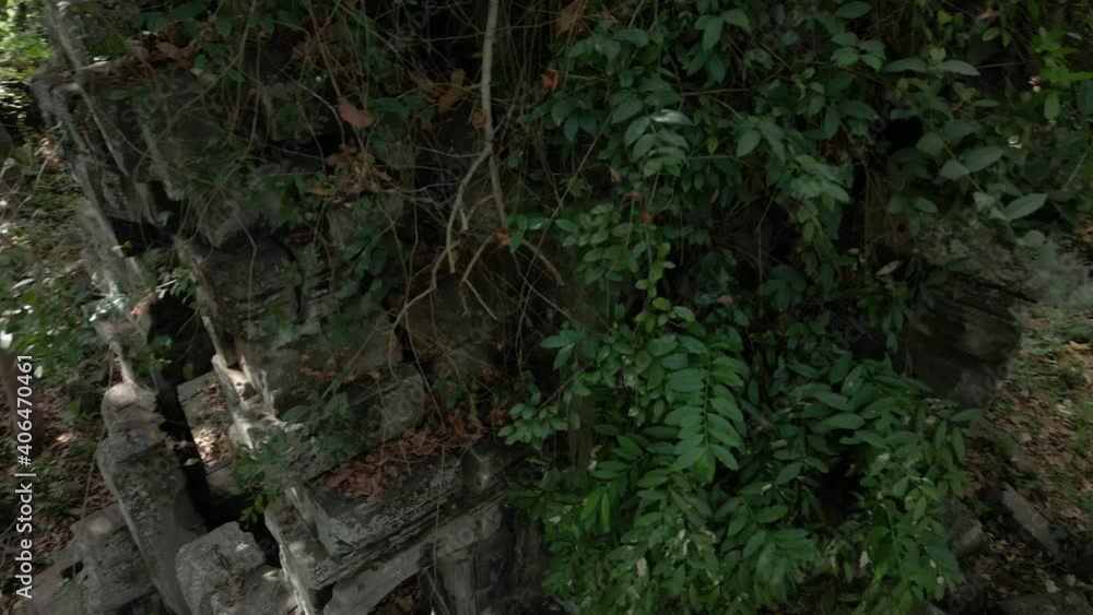 Forgotten Temples of Cambodia. Overgrown Angkorian temple Chamreang - birds eye drop into jungle and reveal temple.jungle, Forgotten Temples of Cambodia. Overgrown Angkorian temple Chamreang - birds eye drop into jungle and reveal temple.jungle,