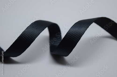 Canvas Print Black glossy nylon twill webbing on white background.