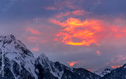 Clouds appear painted with bright red and orange in beautiful winter sunset
