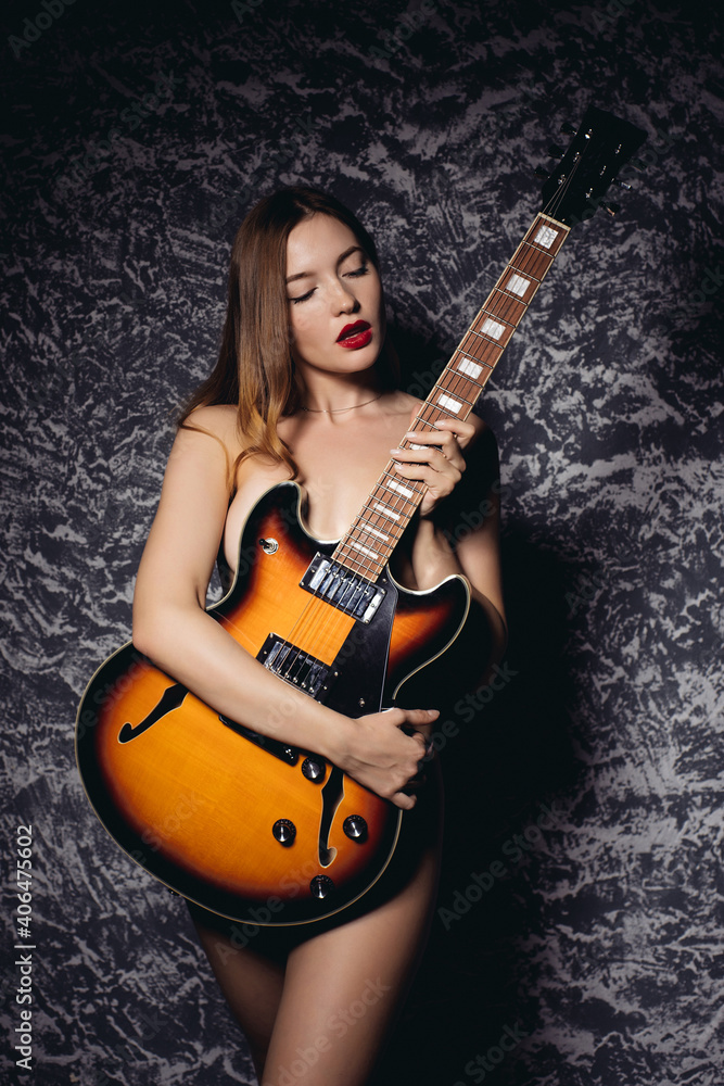 Beautiful young sexy woman with guitar. Musical girl Stock Photo | Adobe  Stock
