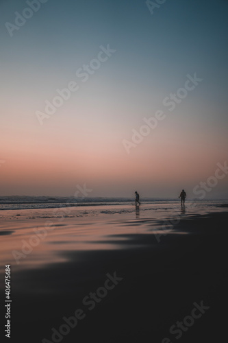 Silhouette of a couple on the beach at sunset in Oregon