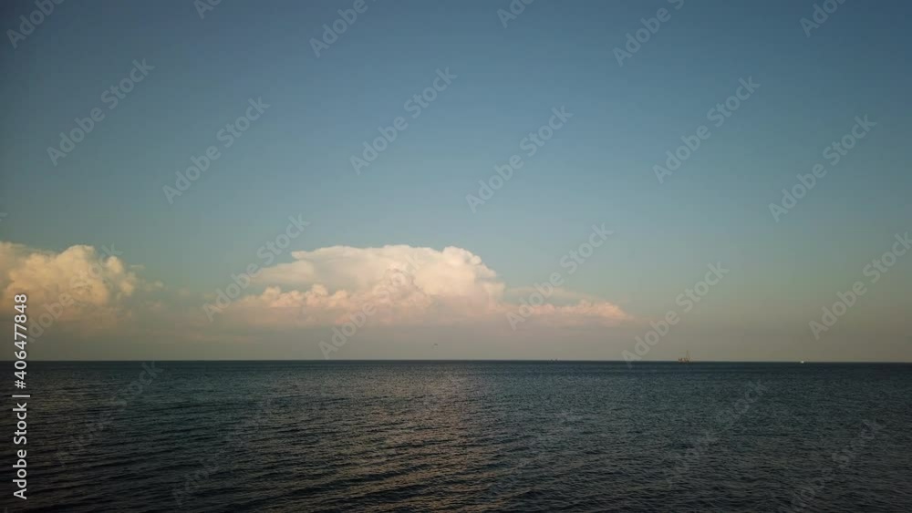 Motion time-lapse of swirling cumulous clouds over lake surface, from afternoon to dusk Motion time-lapse of swirling cumulous clouds over lake surface, from afternoon to dusk