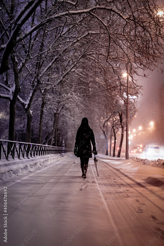 Woman in dark coat standing  during snowfall in Madrid, 8th January
