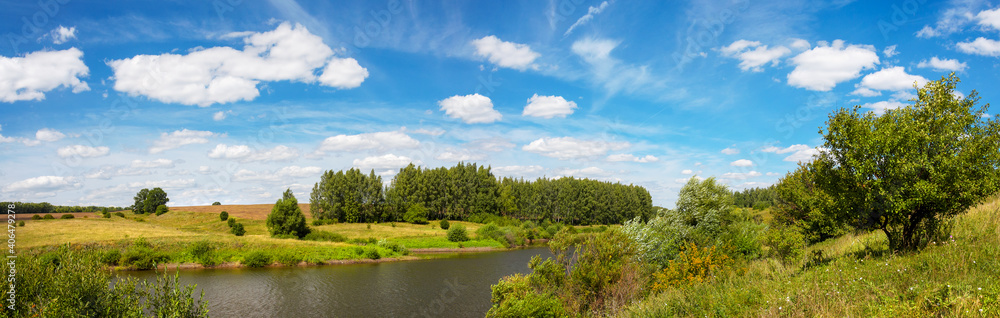 Summer rural panoramic landscape with beautiful river and green forest in sunny day Summer rural panoramic landscape with beautiful river and green forest in sunny day