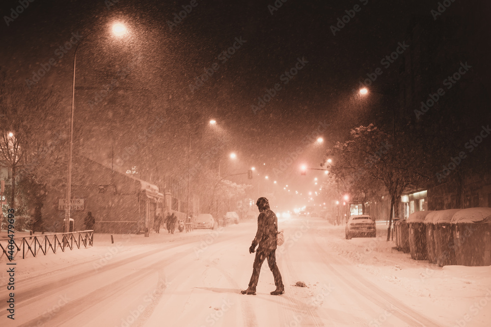 Woman in dark coat standing  during snowfall in Madrid, 8th January
