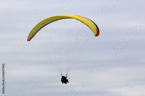 Tandem Paraglider flying wing in a cloudy sky	