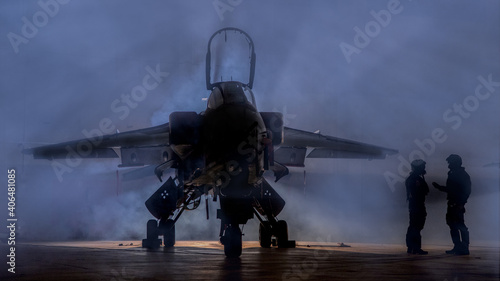 Photographie Fighter Pilot, dramatic top gun style silhouette of pilots standing near a jet fighter in smoke