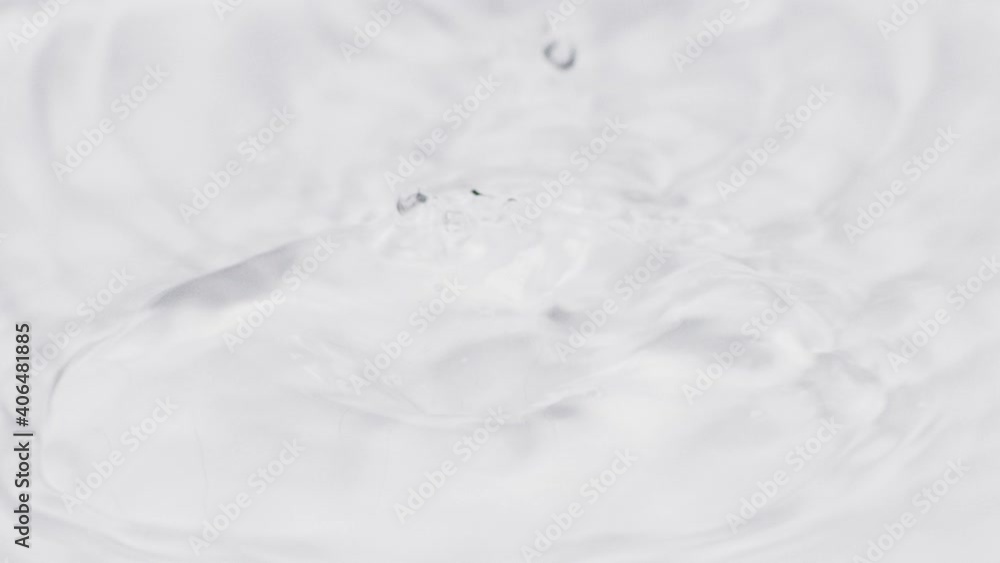 Slow-motion of falling water drops in pure crystal water. Close-up