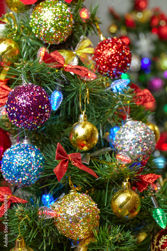 Multicolored Christmas balls decorate the Christmas tree