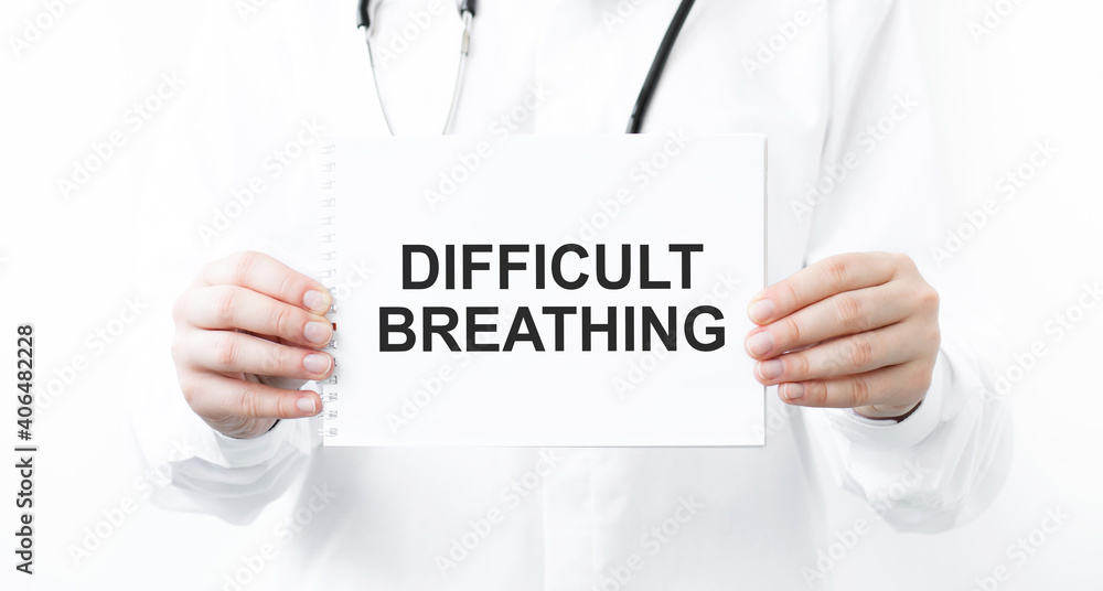 Doctor holding notebook with text DIFFICULT BREATHING, medical concept Doctor holding notebook with text DIFFICULT BREATHING, medical concept