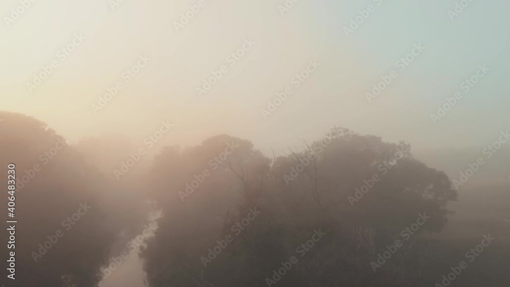 Aerial drone view of sunrise over misty river. Calmness, relaxation, meditation, solitude, beauty of nature concept Aerial drone view of sunrise over misty river. Calmness, relaxation, meditation, solitude, beauty of nature concept