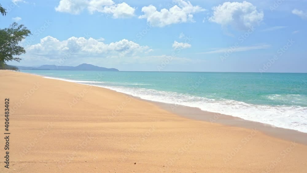 Wild island - Empty yellow sandy beach line and turquoise sea water, Slow calm sea tides and cloudy sky without people tree, Generic, static, mountains on background Wild island - Empty yellow sandy beach line and turquoise sea water, Slow calm sea tides and cloudy sky without people tree, Generic, static, mountains on background