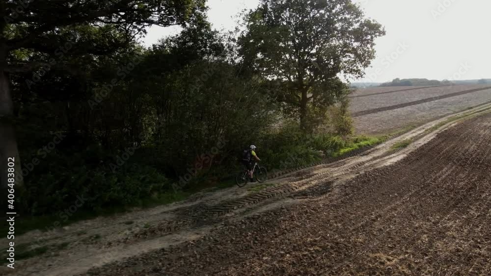 Drone tracking side profile Mountain bike on field track Drone tracking side profile Mountain bike on field track