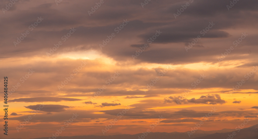 Beautiful colorful bright dramatic sunset sky with orange clouds. Nature sky background.