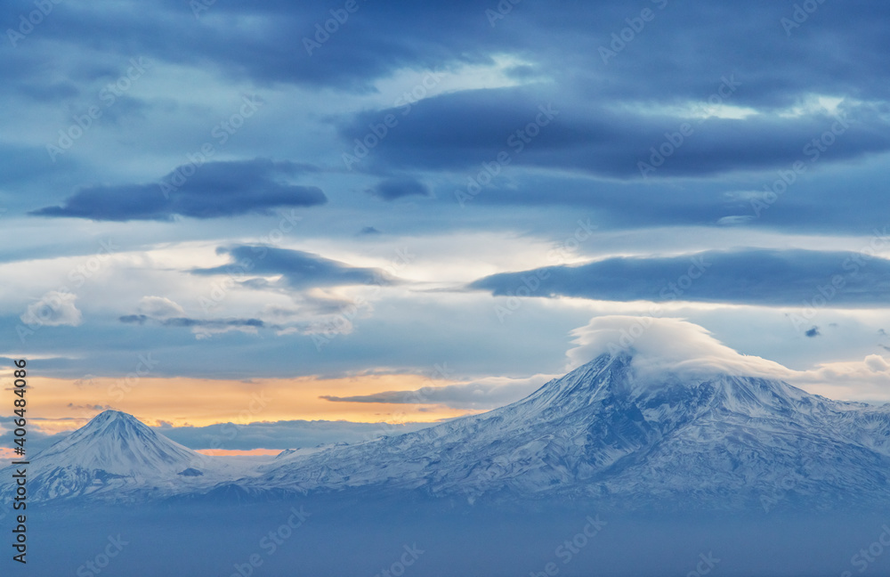 Beautiful winter landscape. Panoramic view on the lake  and mountains peaks snow-covered. Dramatic sunset. 