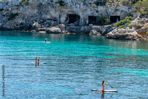 Paddle surf in front of the caves of Portals Vells, Calvia, Mallorca, Balearic Islands, Spain