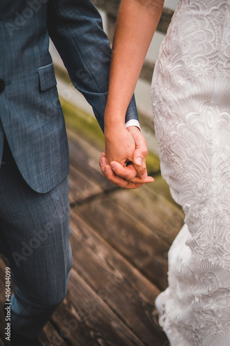 Bride and groom holding hands on dock