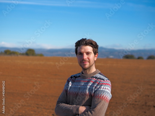 man in the countryside, wearing a sweater